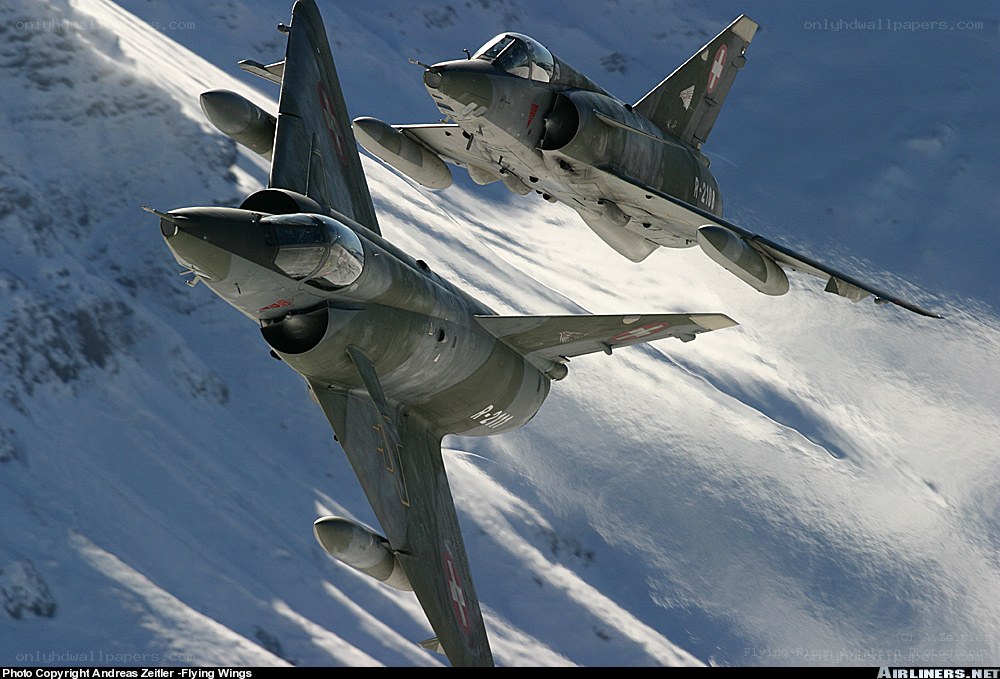Swiss jets over snowy mountains
