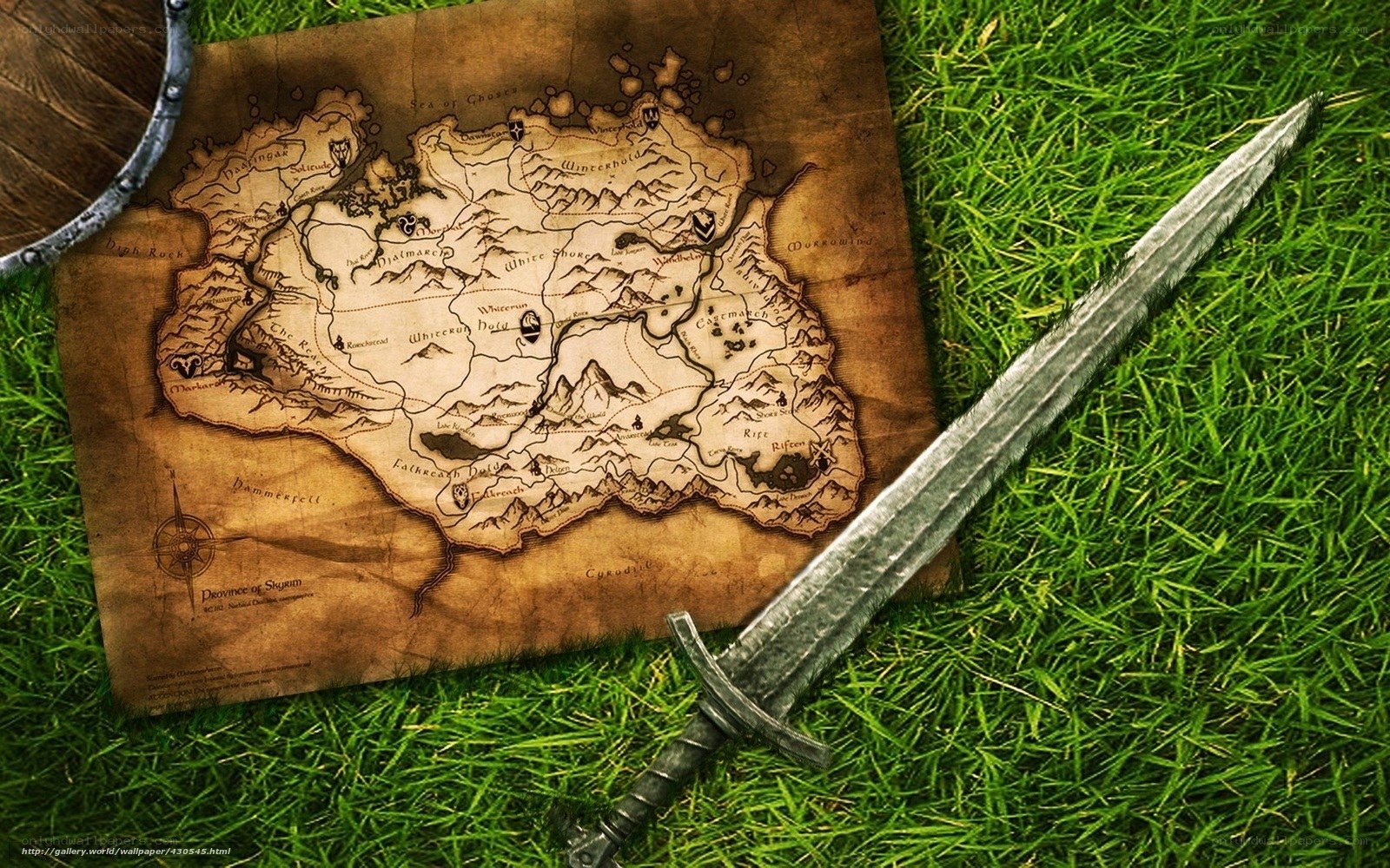 sword and map on grass