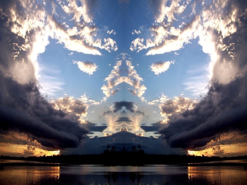 Symmetrical clouds over water
