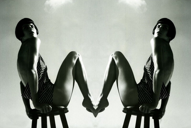 Symmetrical woman on stools