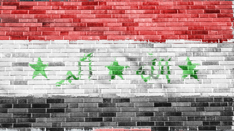 Syrian flag on brick wall