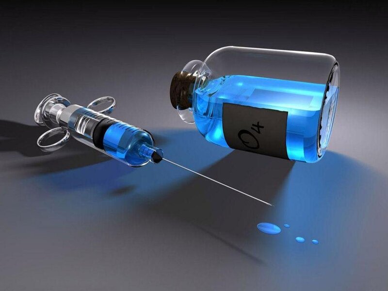 syringe and vial with blue liquid