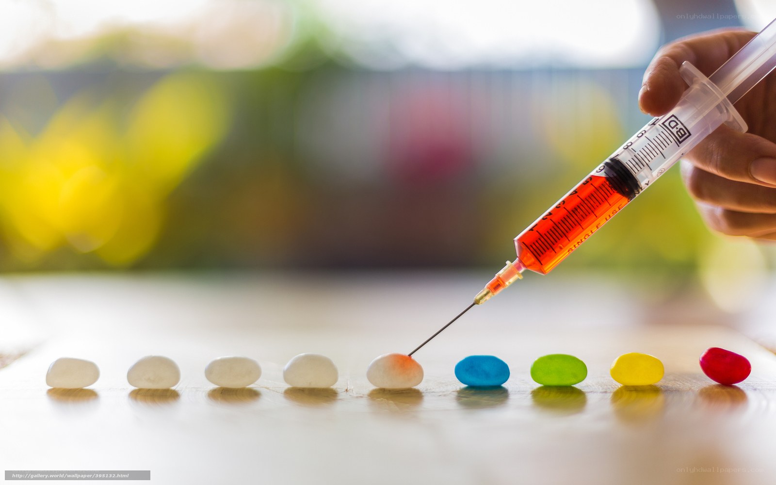 syringe injecting colorful candy