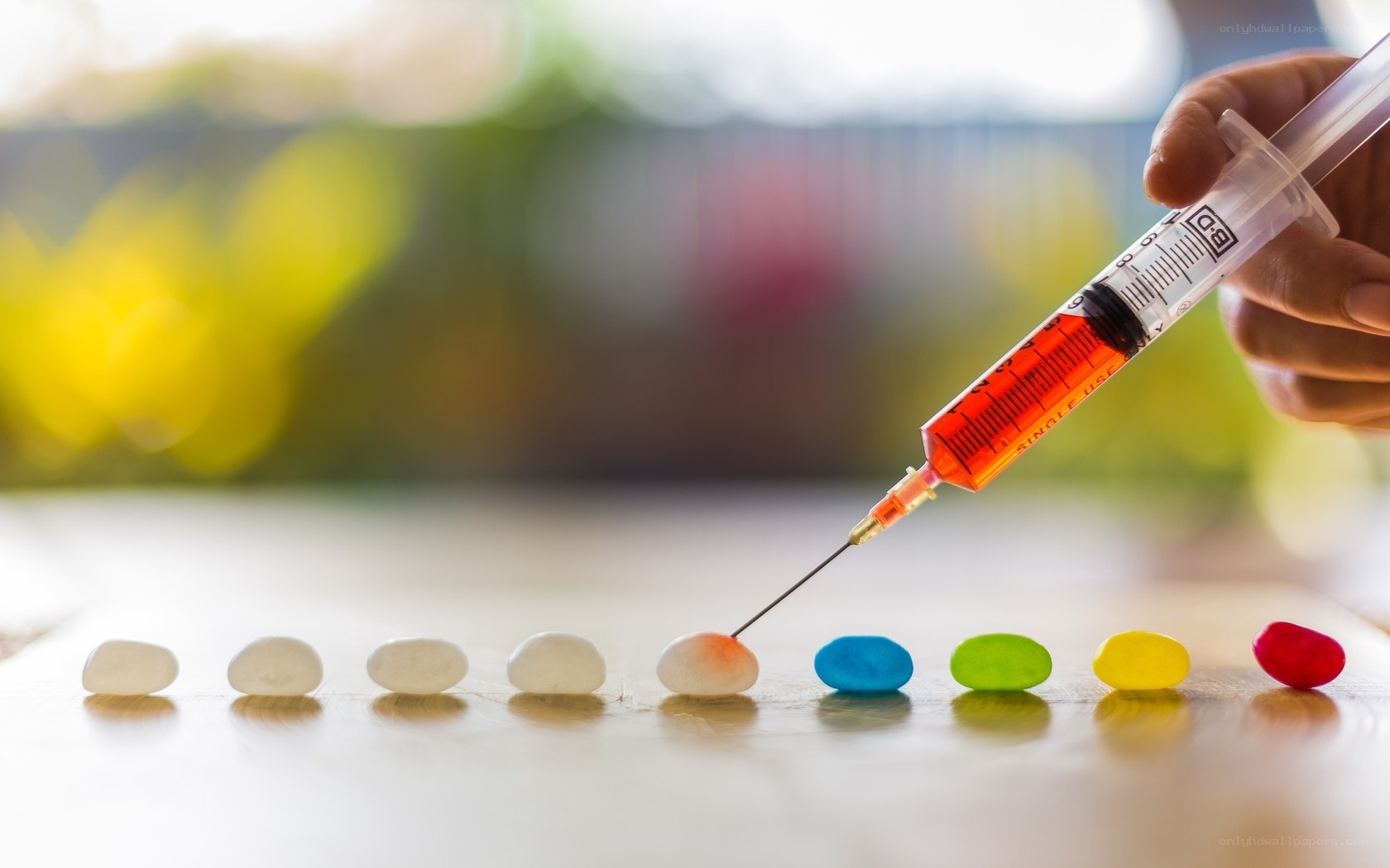 syringe injecting jelly beans
