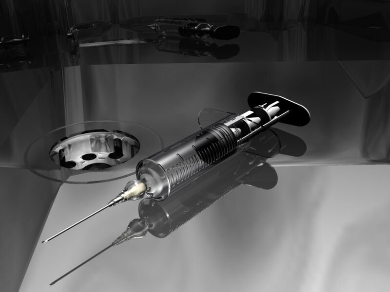 Syringe on reflective surface