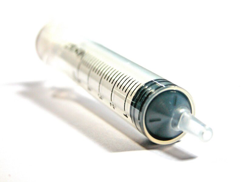 syringe on white surface