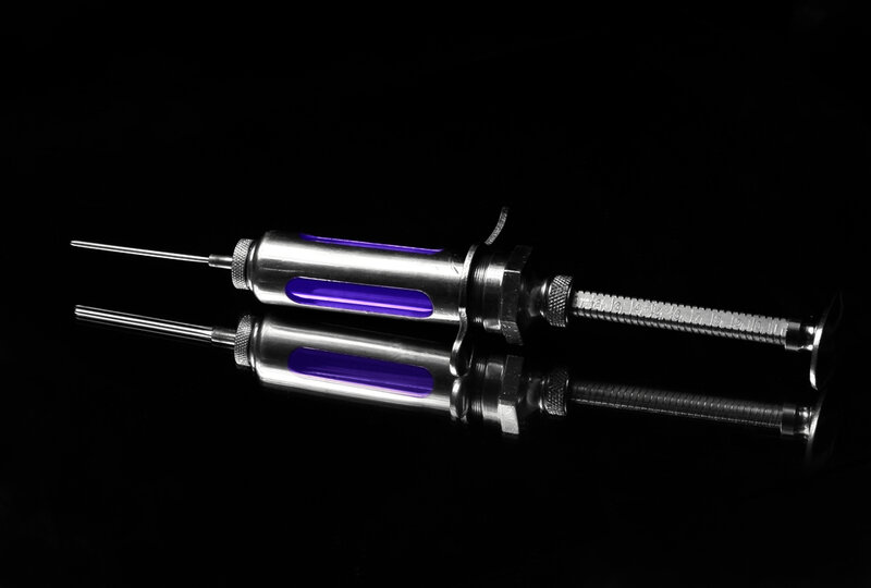 Syringe with purple liquid