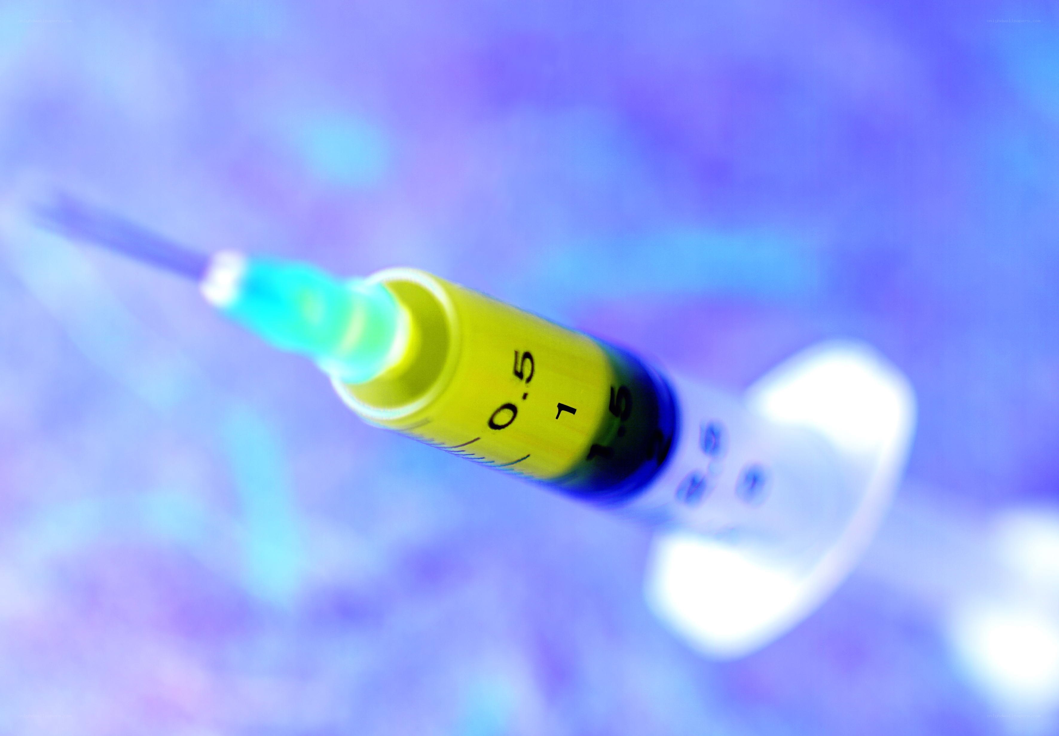 syringe with yellow liquid