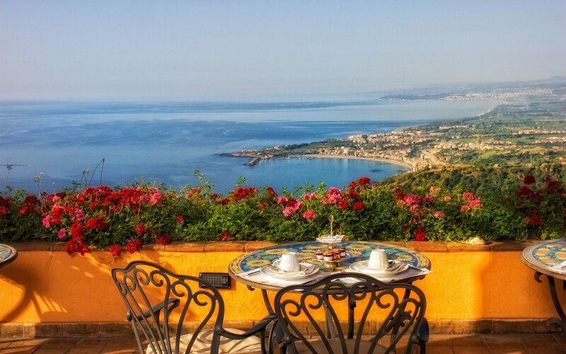 Table with Flowers and Sea View — Blue
