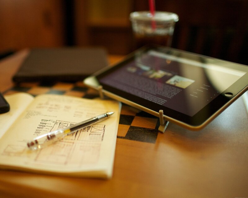 Tablet and notebook on a table