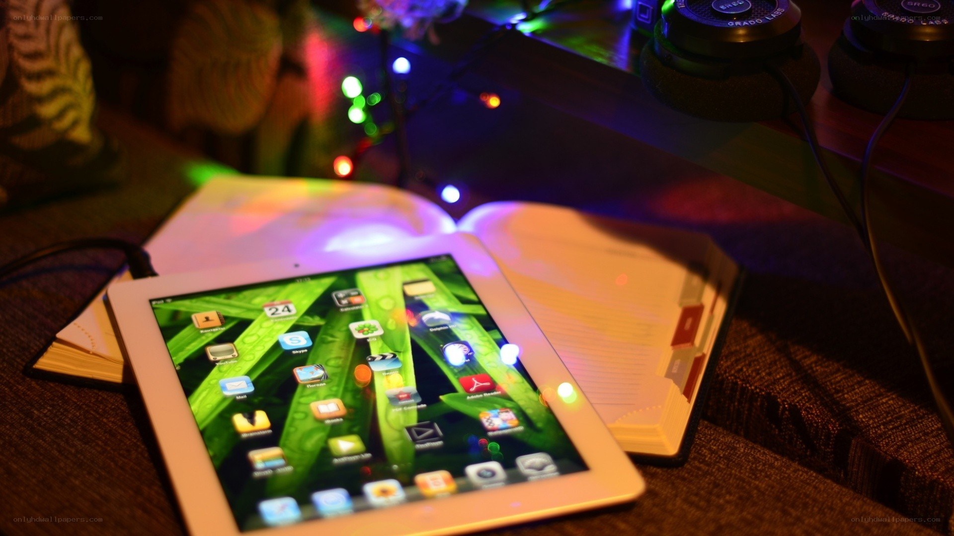 tablet on open book with lights