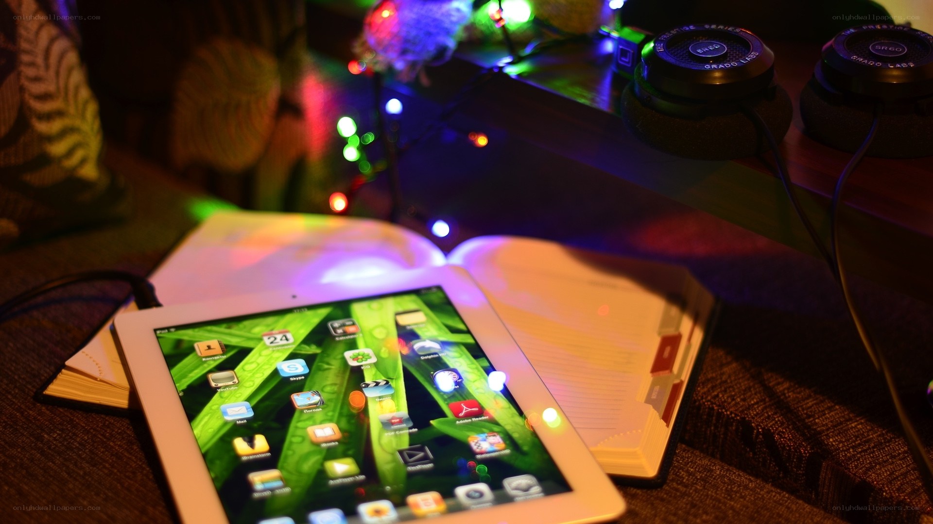 tablet on open book with lights