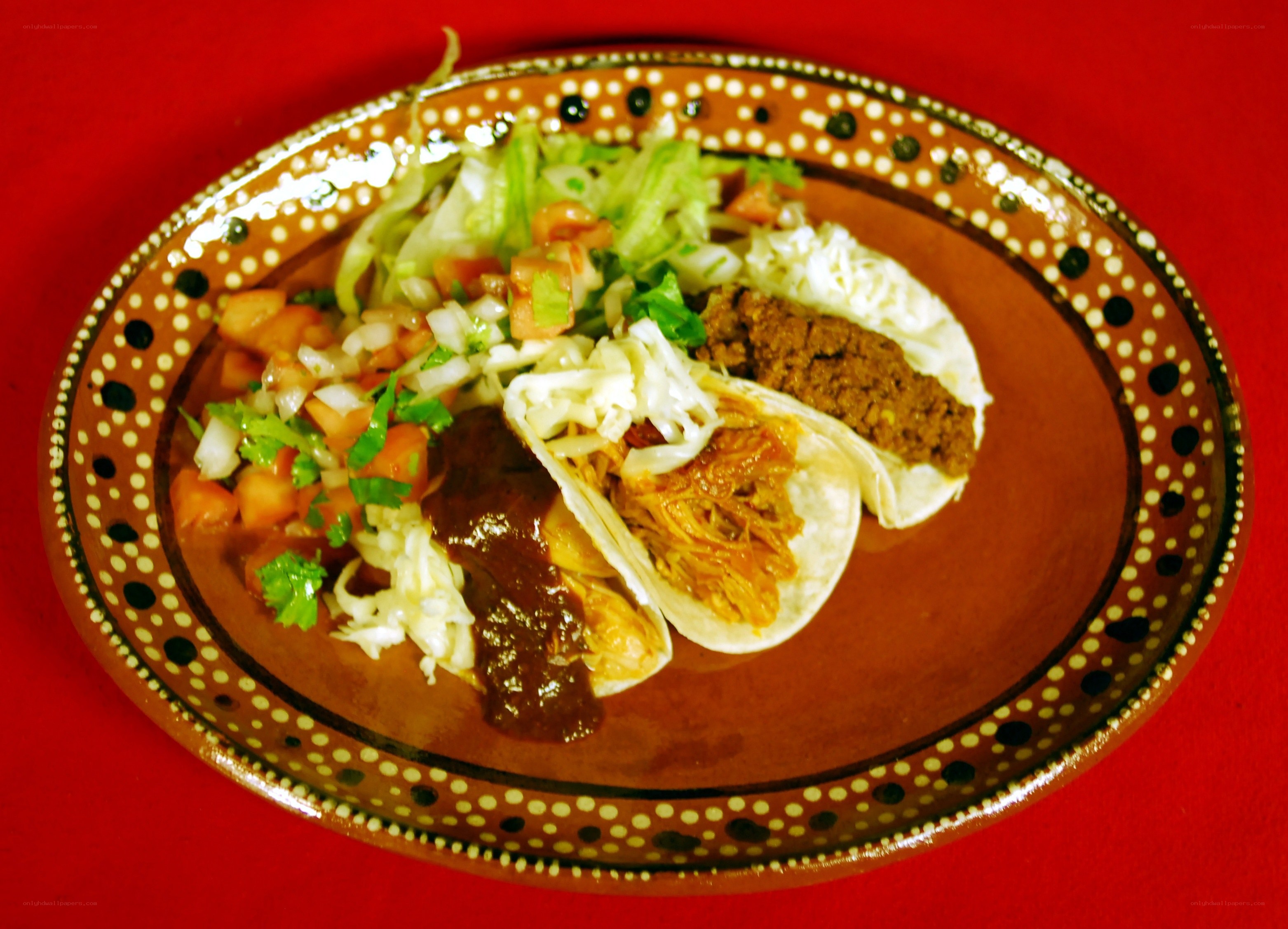 tacos with toppings on a plate