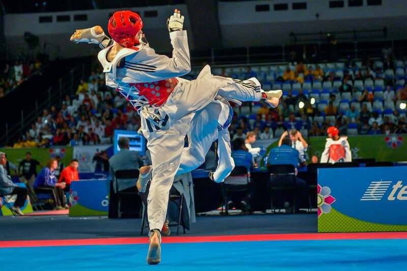 Taekwondo athlete executing high kick