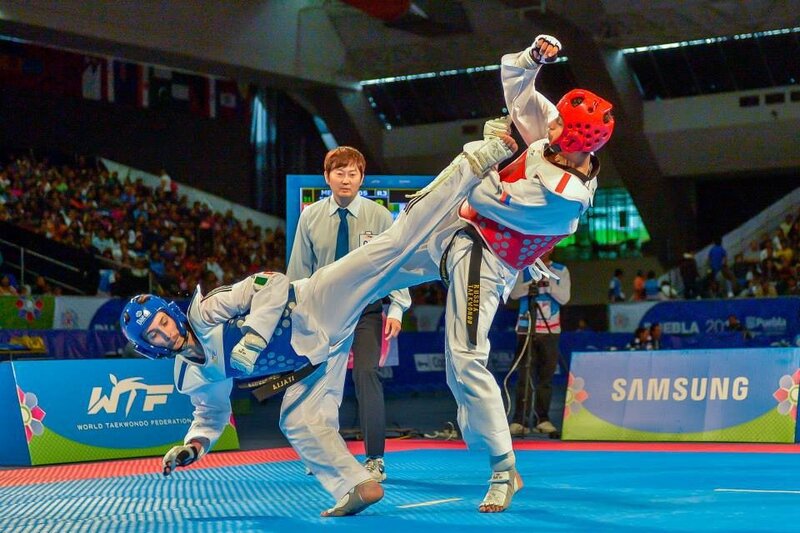 Taekwondo Athletes in Action — Blue, Intense, Photograph, Referee, Audience, Competition Mat