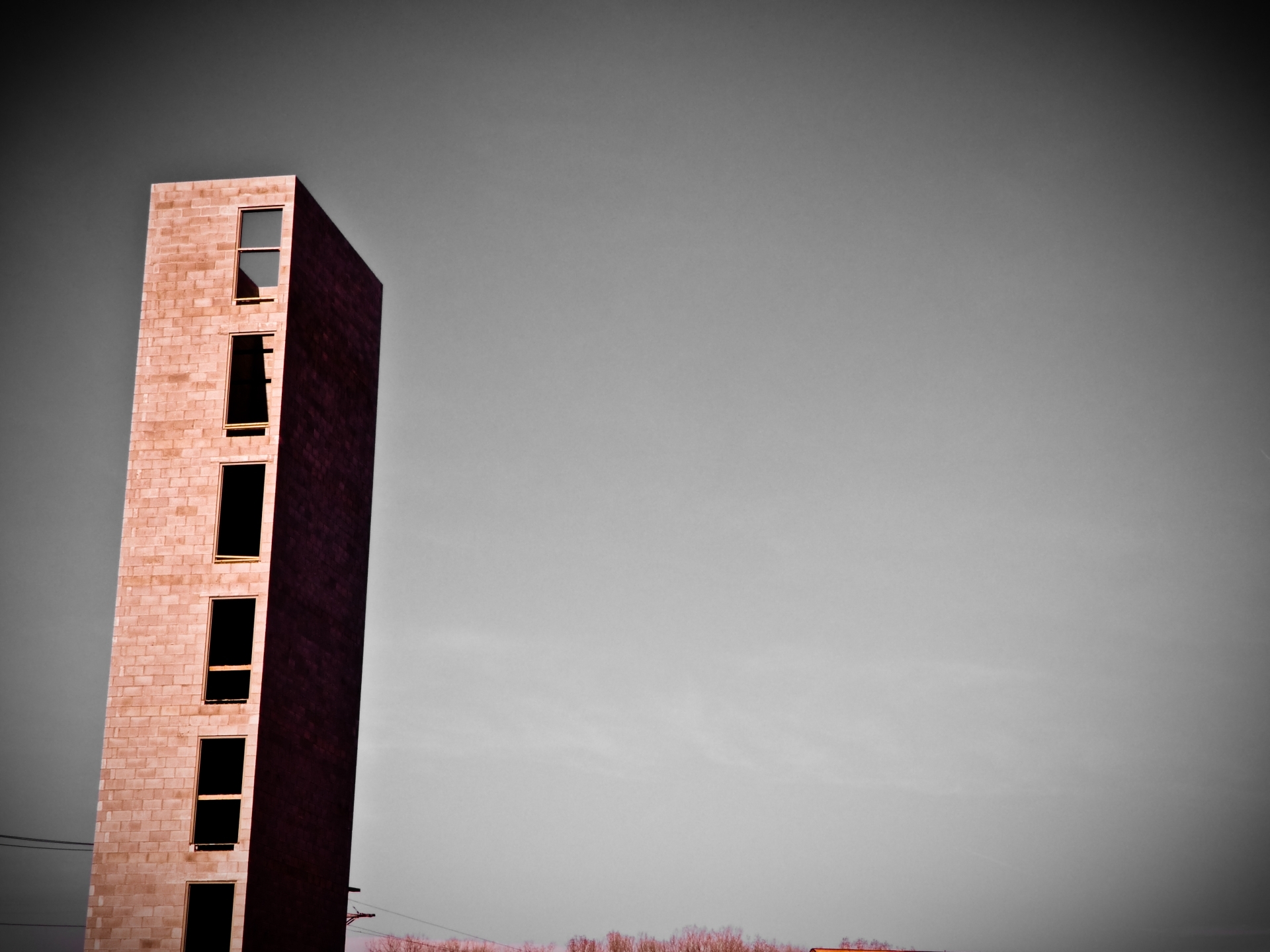 Tall brick building under gray sky