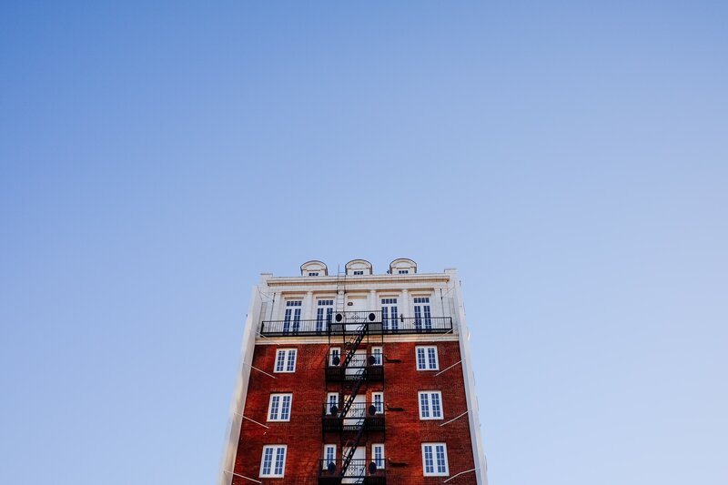tall brick building with fire escape