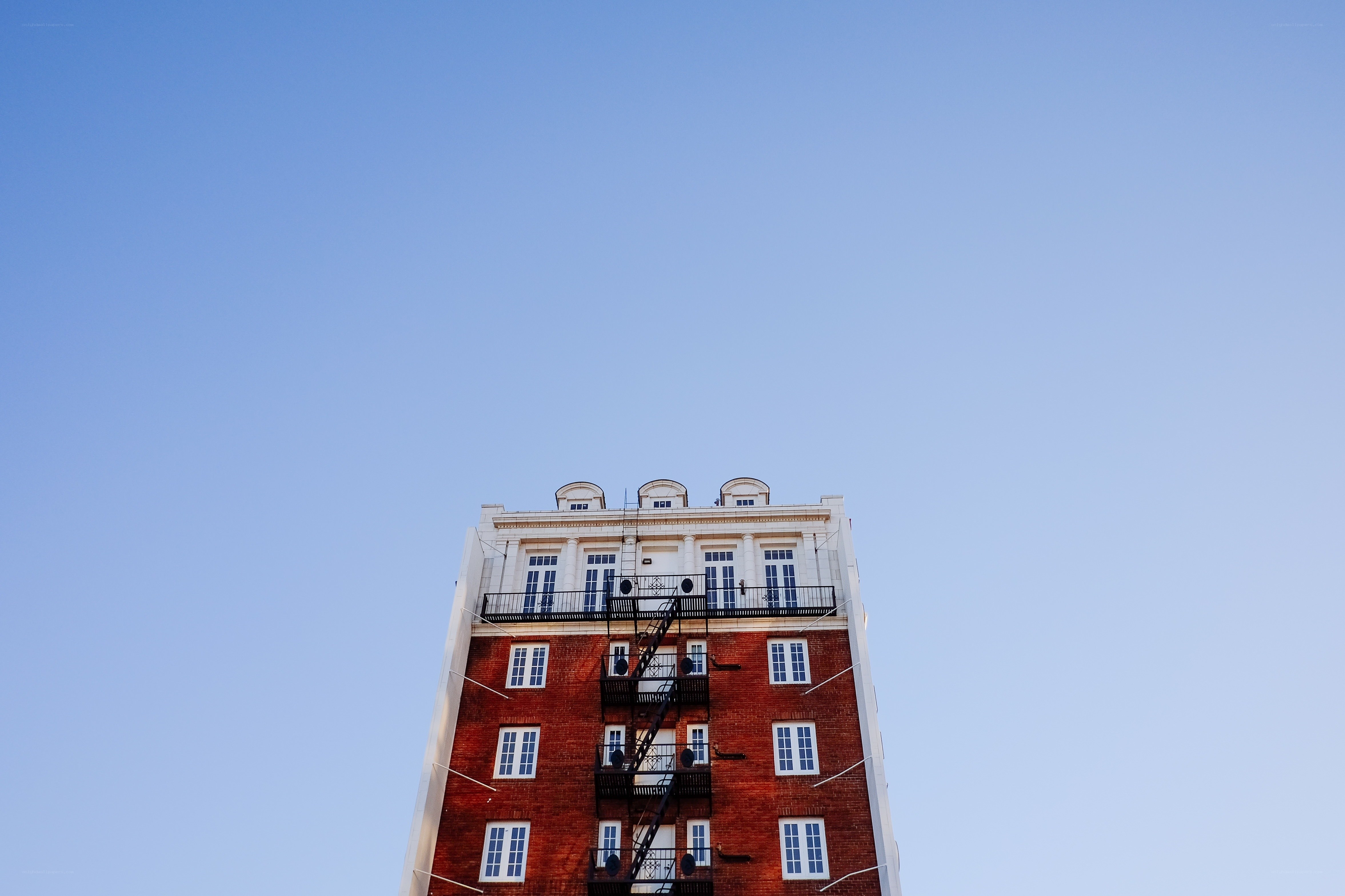 tall brick building with fire escape