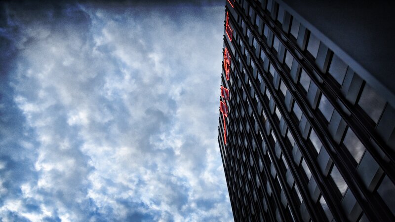 Tall Building with Neon Sign