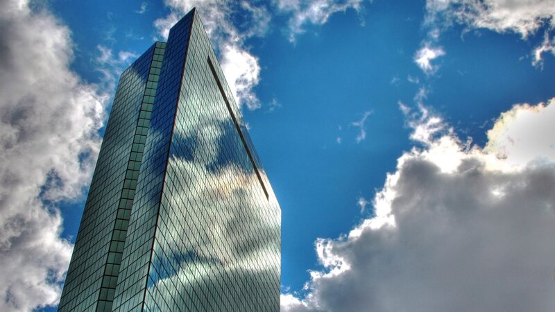 tall glass skyscraper against blue sky
