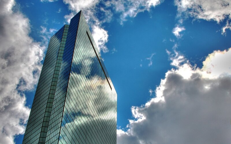 tall glass skyscraper against blue sky