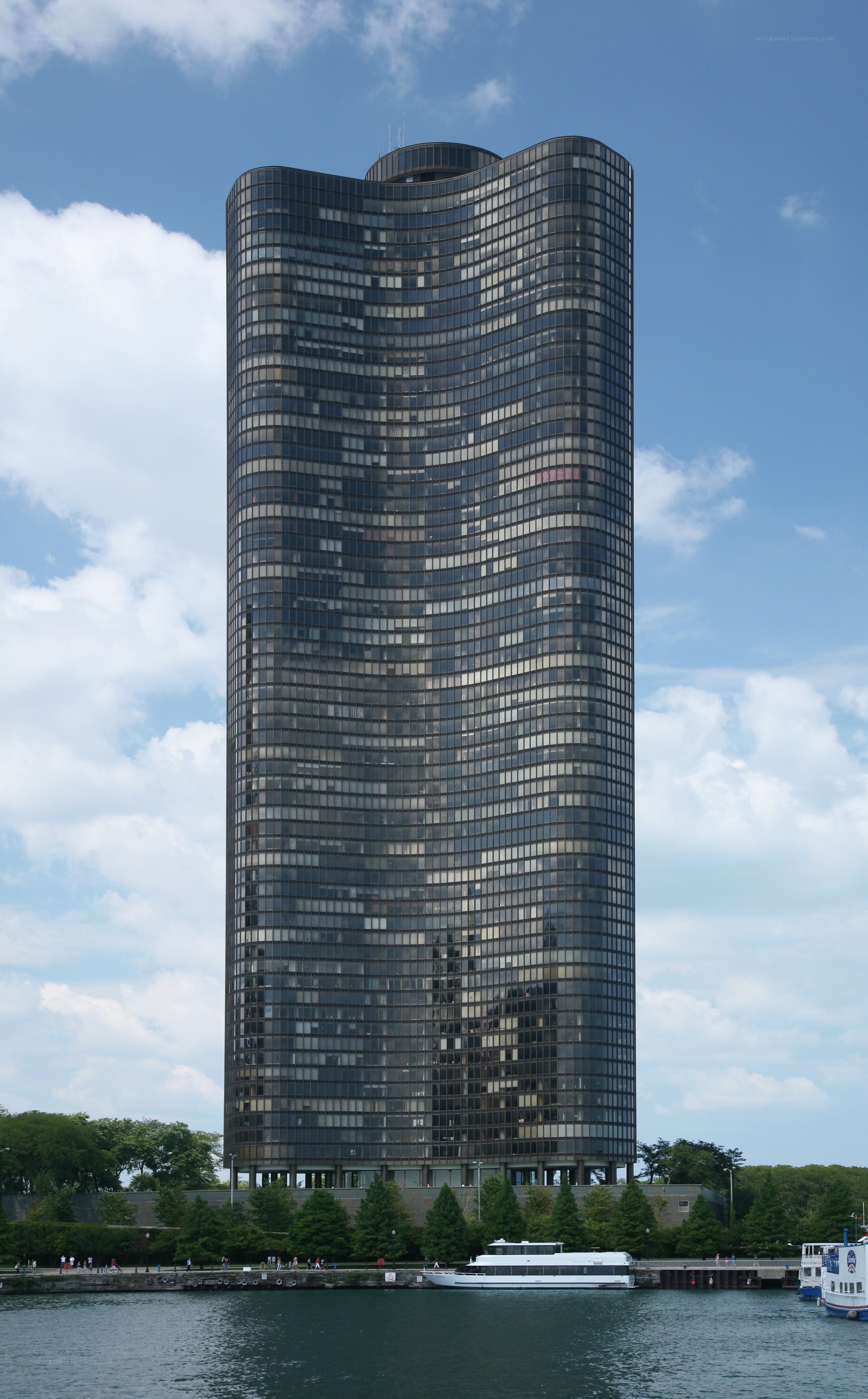 tall glass skyscraper by water