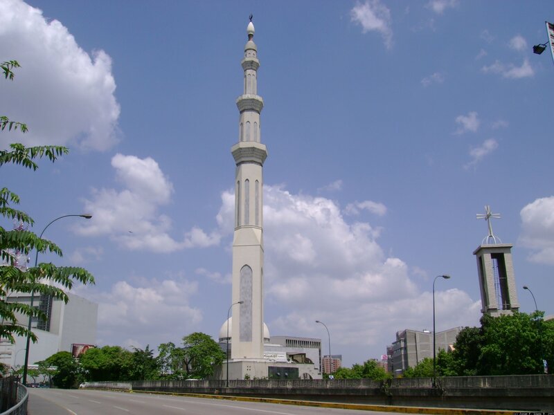 Tall minaret against blue sky