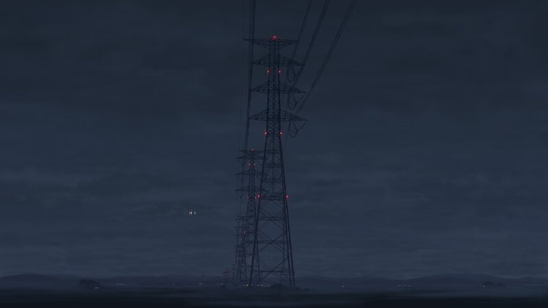 tall power line tower at night