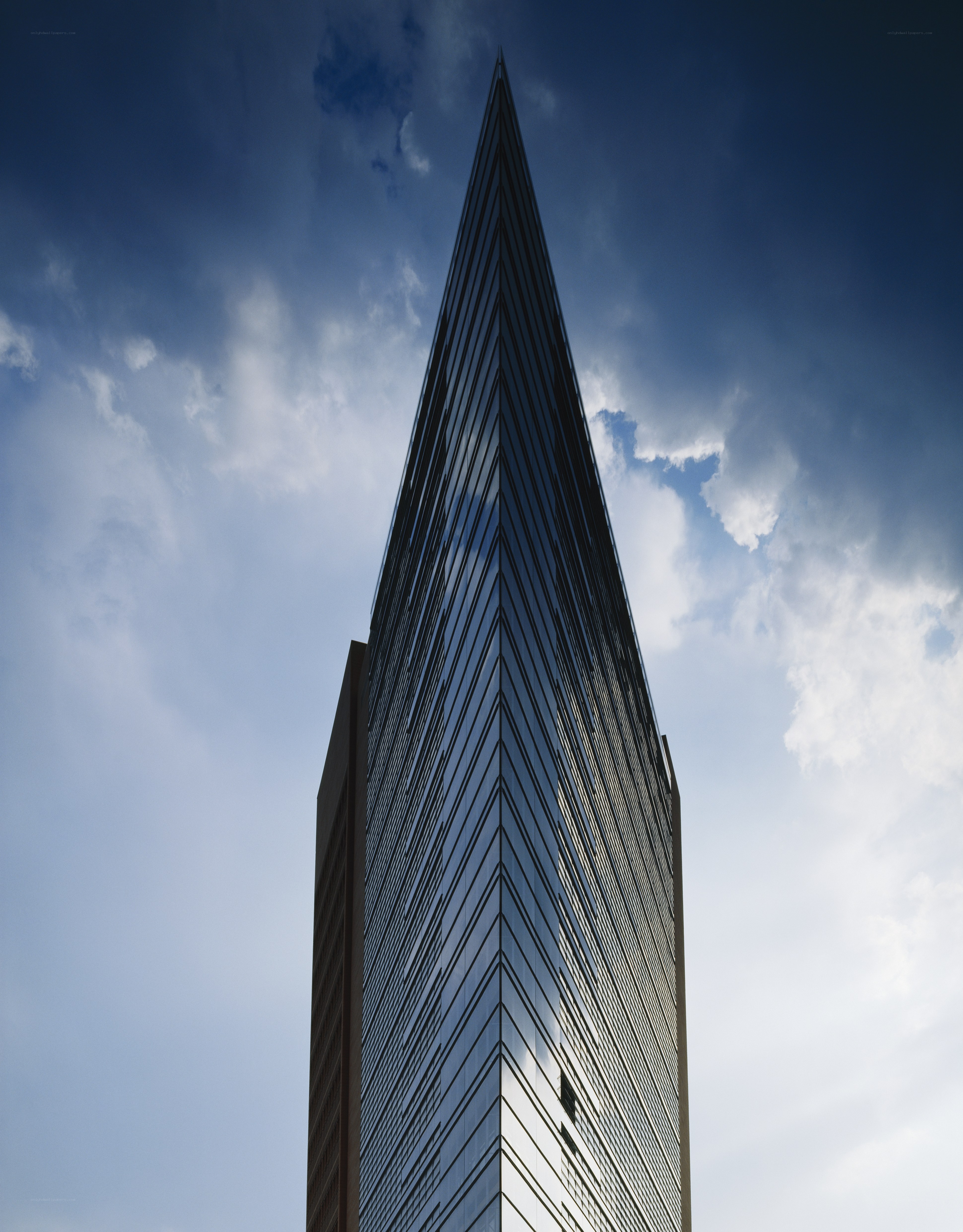 tall skyscraper against cloudy sky