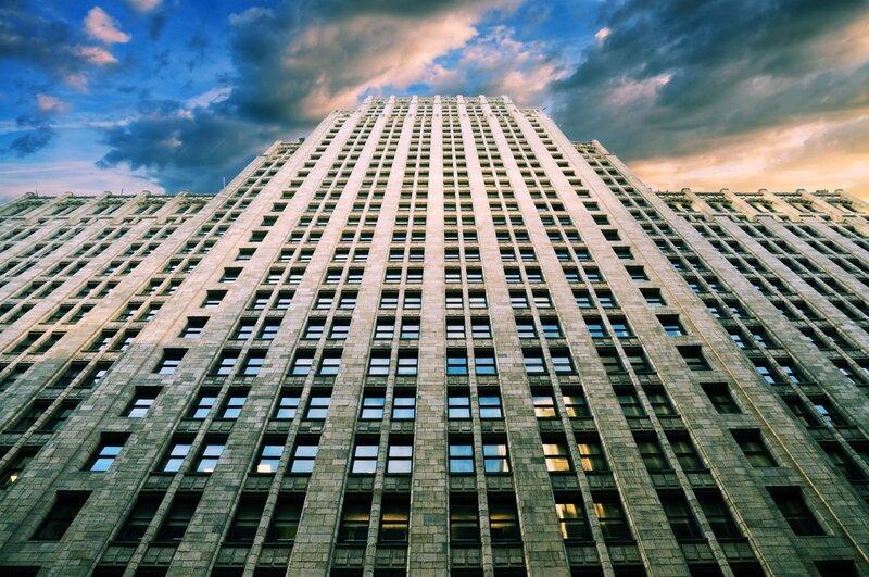 Tall Stone Building — Blue, Dramatic, Sunset, Photograph, Sky, Clouds, Windows, Gray, Orange