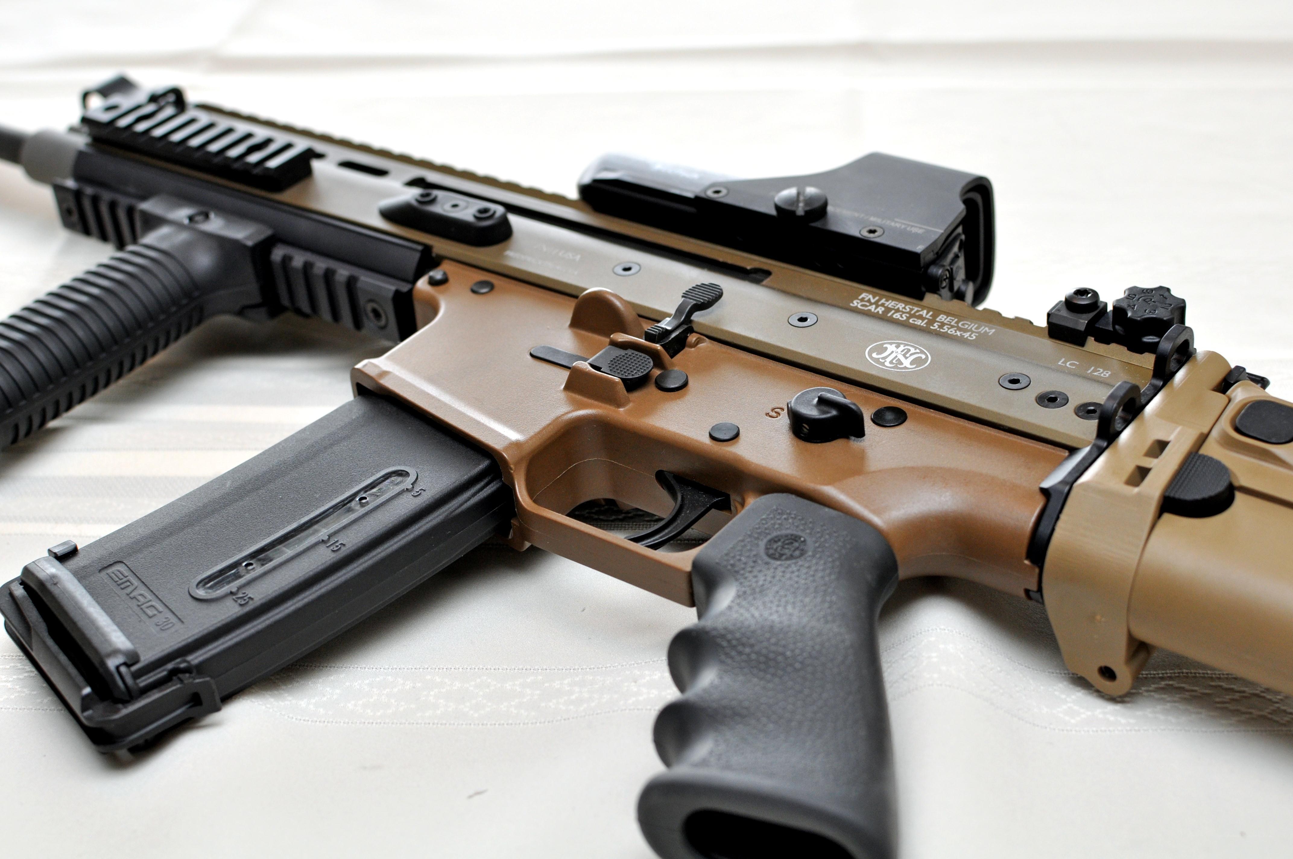 tan and black rifle