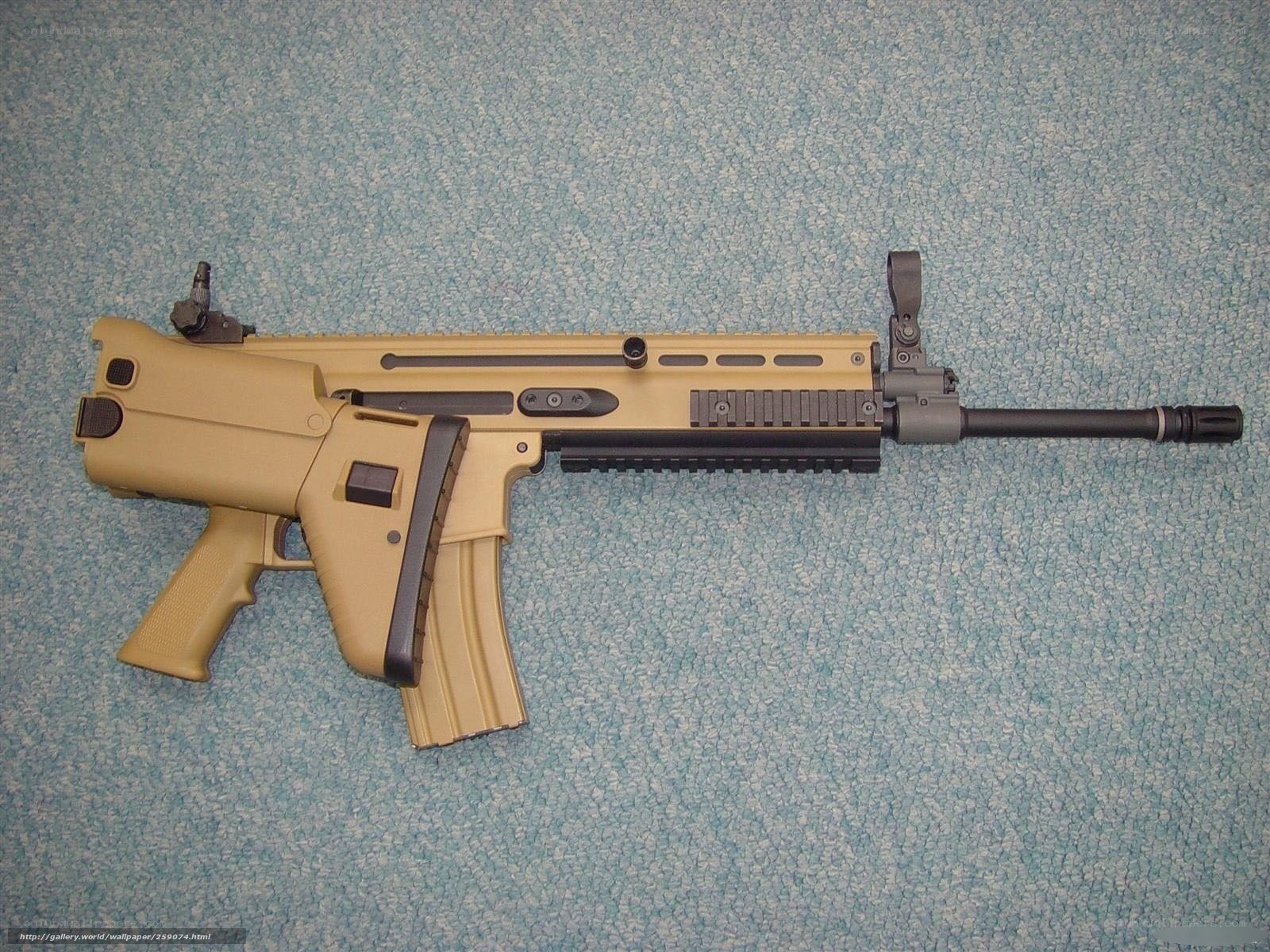 tan assault rifle on carpet