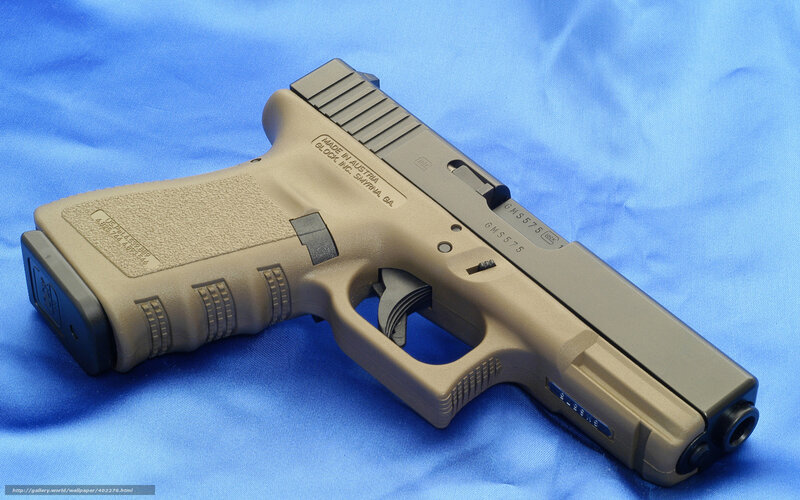 tan-colored handgun on blue cloth