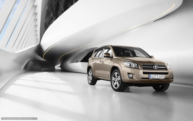 Tan Toyota RAV4 in modern architecture