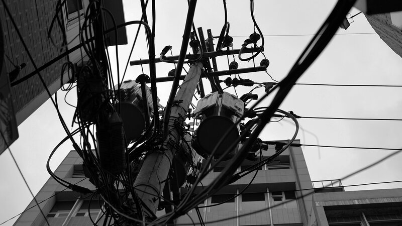 tangled utility wires on a pole