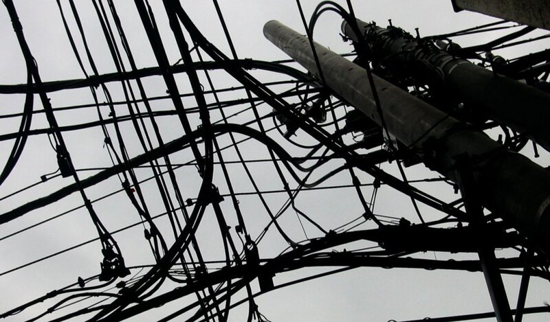 tangled utility wires on pole