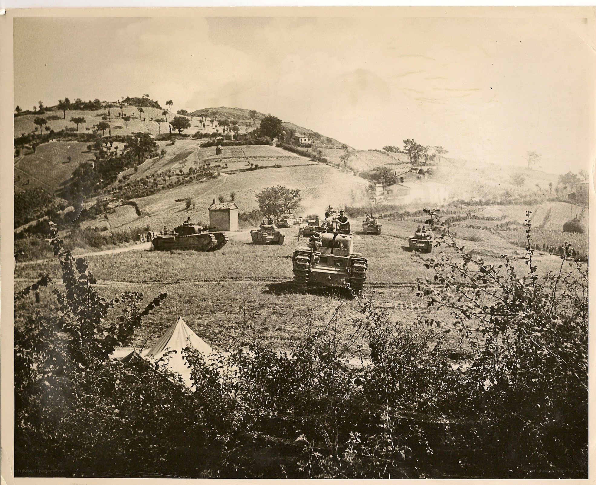 Tank convoy in rural landscape