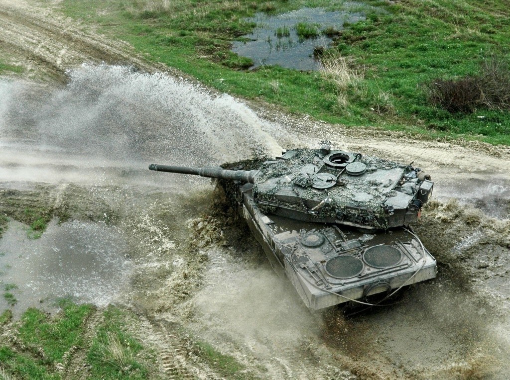 tank crossing muddy terrain