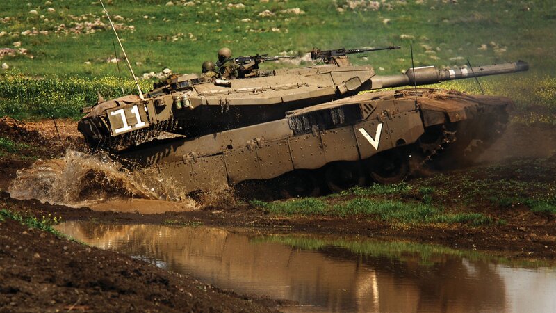 Tank crossing muddy terrain