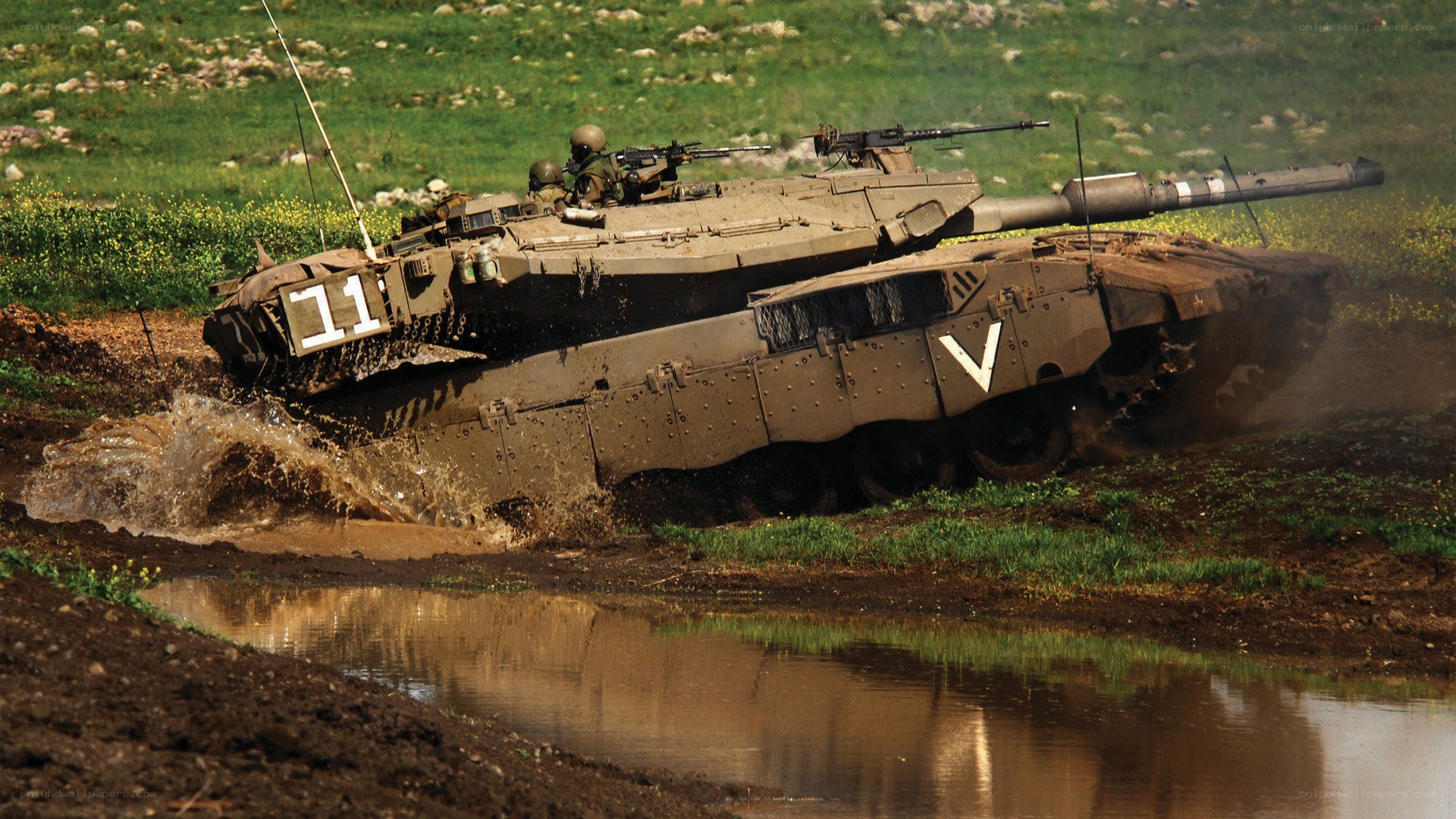 Tank crossing muddy terrain