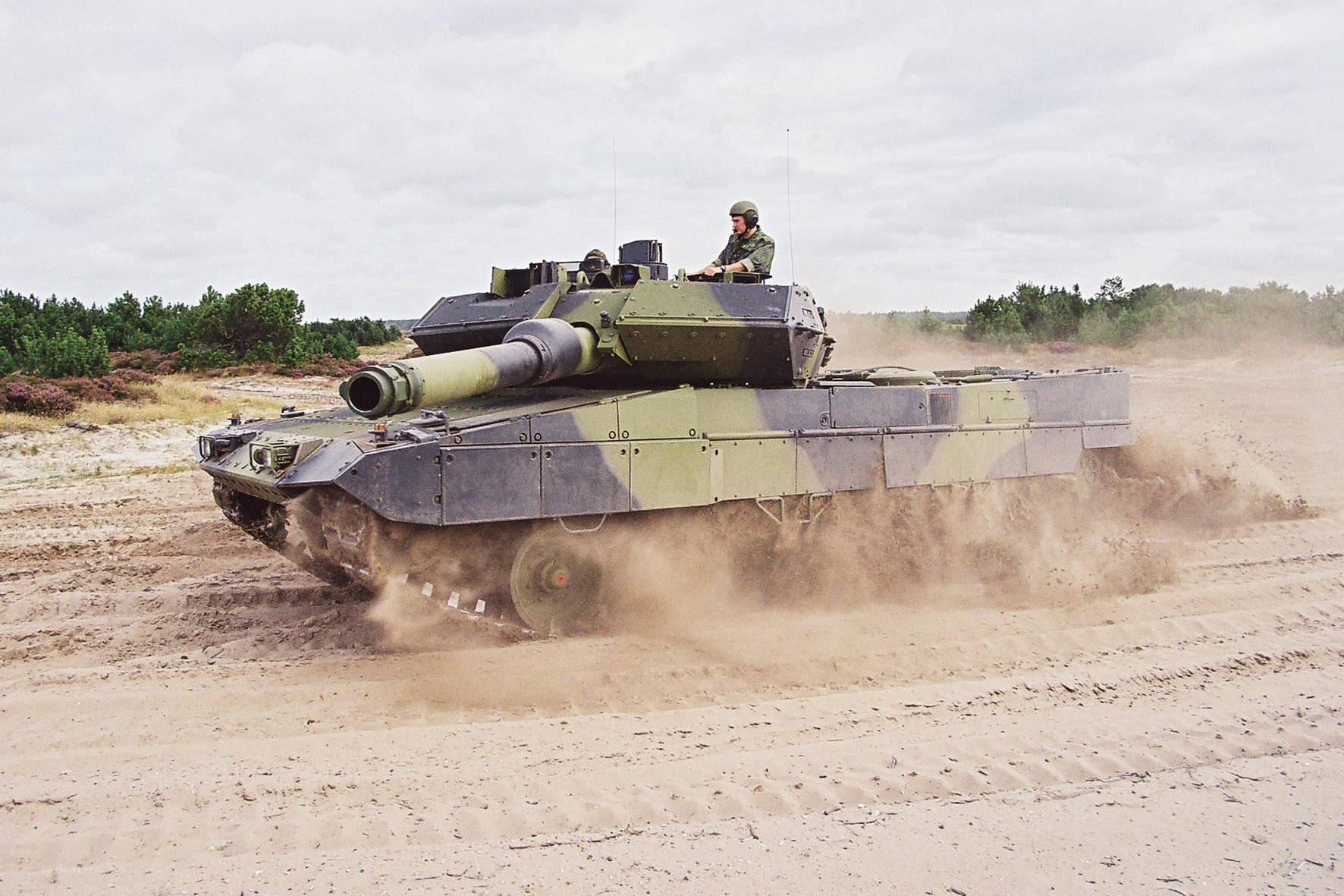 Tank driving on a dirt field