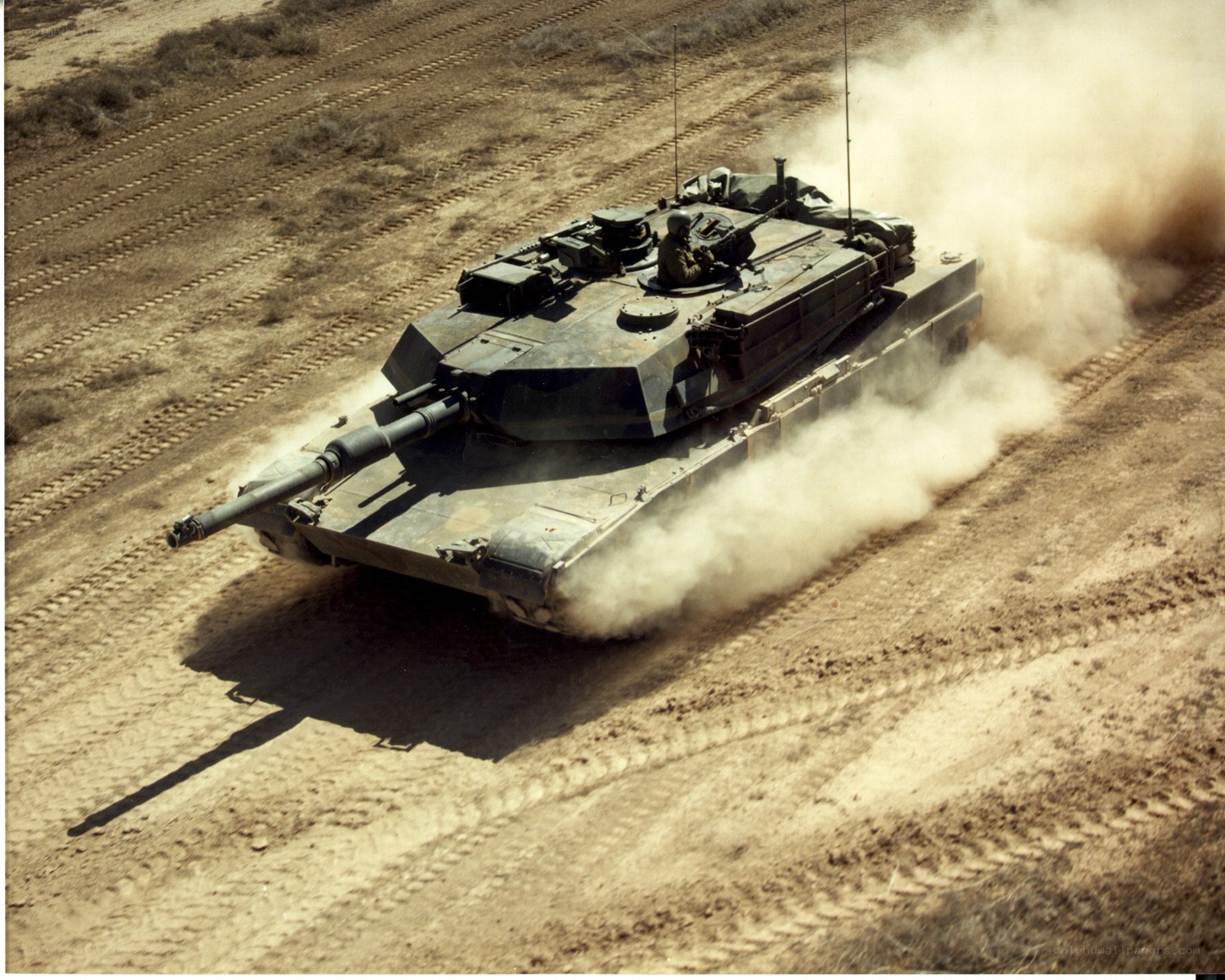 tank driving on dirt field