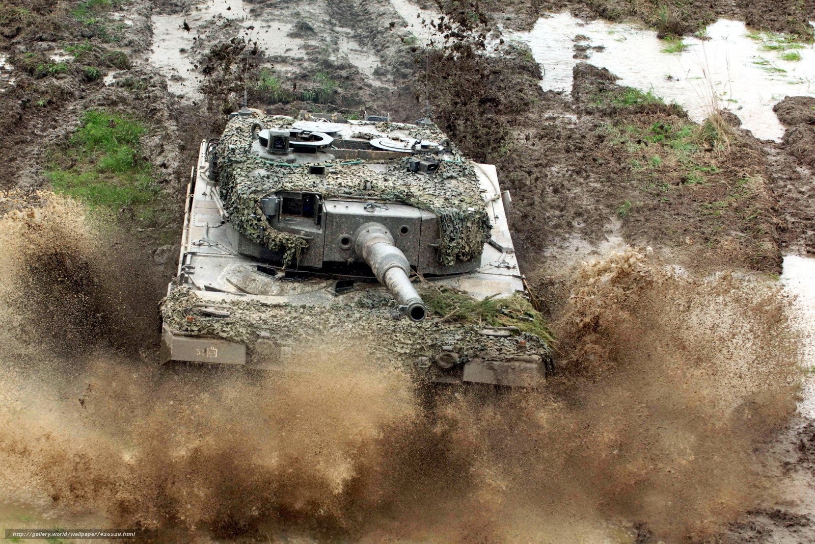 tank driving through muddy terrain