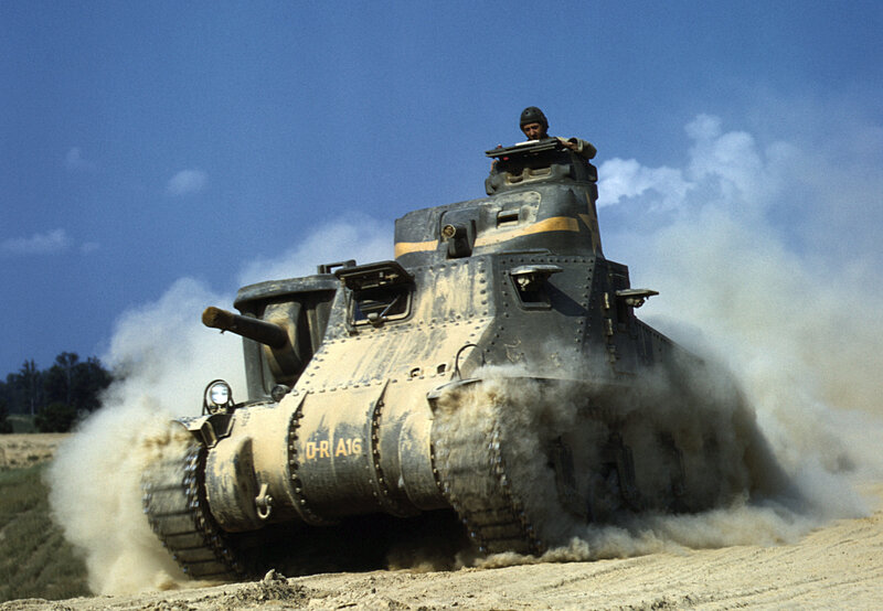 Tank in motion on dirt field
