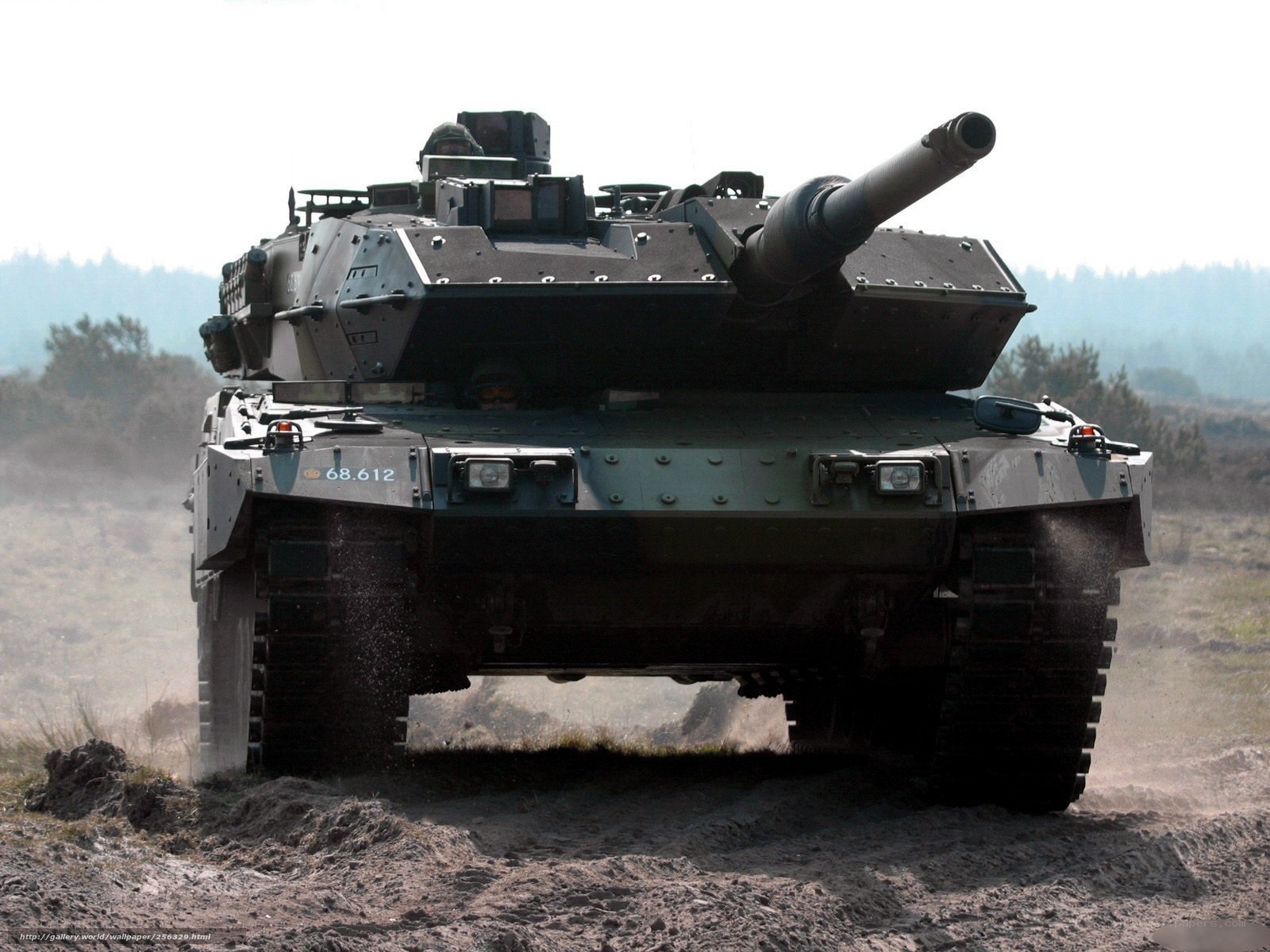 Tank in motion on dirt field