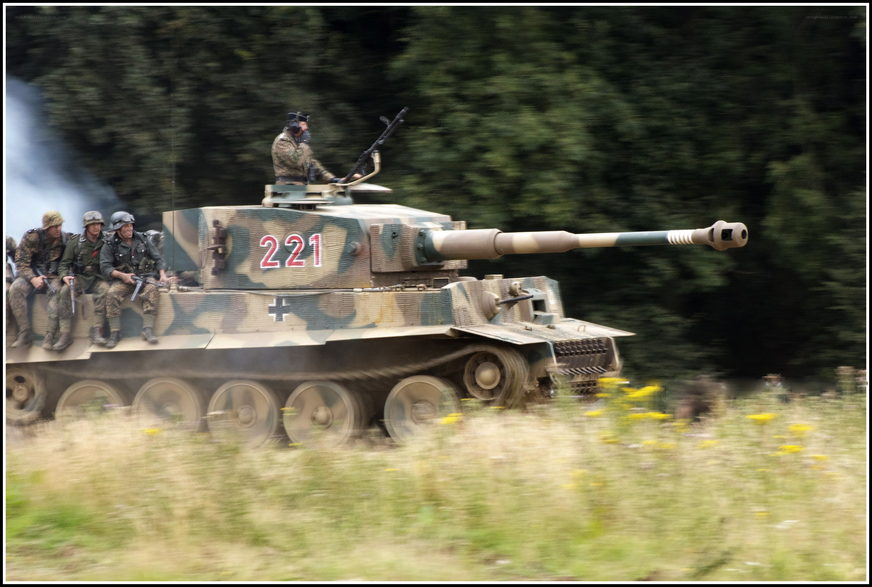Tank in motion with soldiers