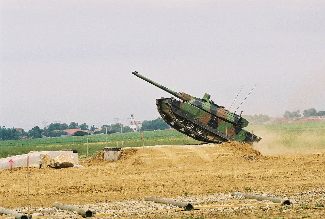 Tank jumping over a dirt mound