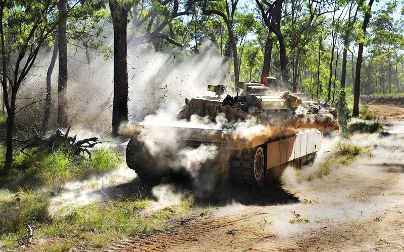 Tank moving through forest