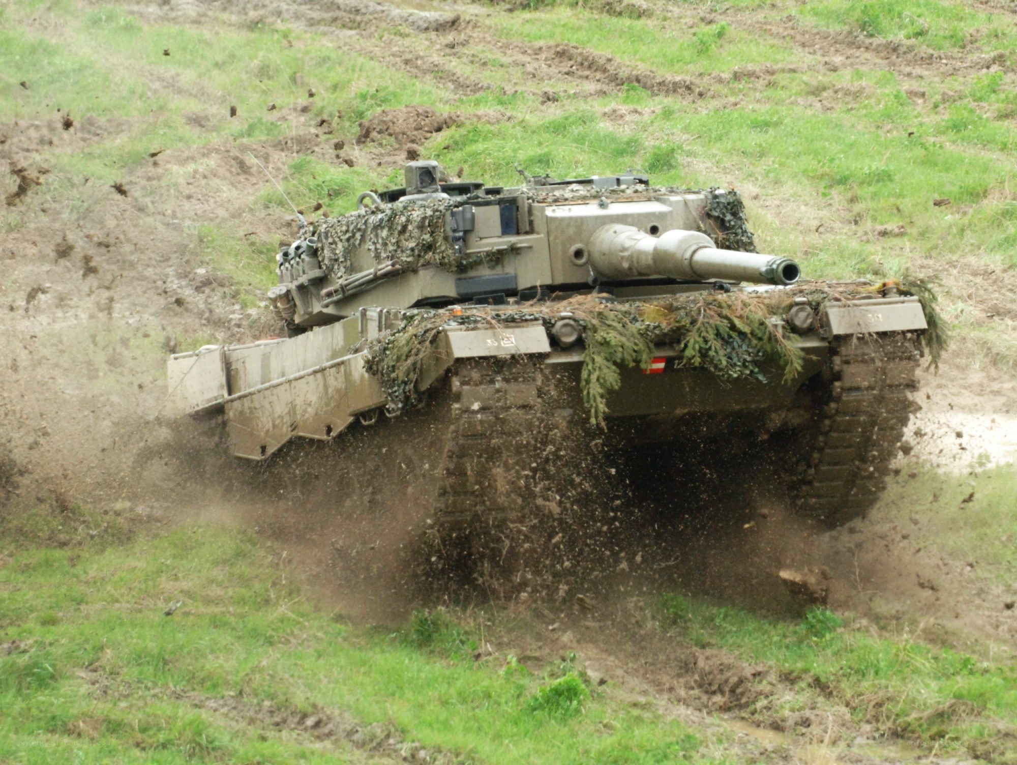 Tank moving through muddy field