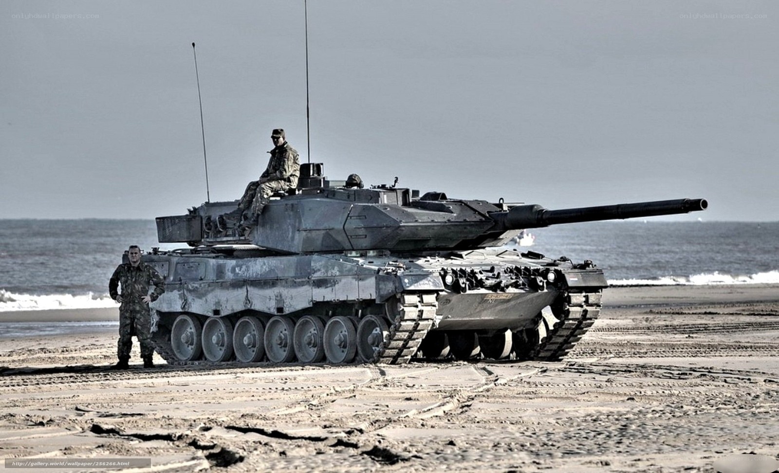 Tank on a beach with soldiers